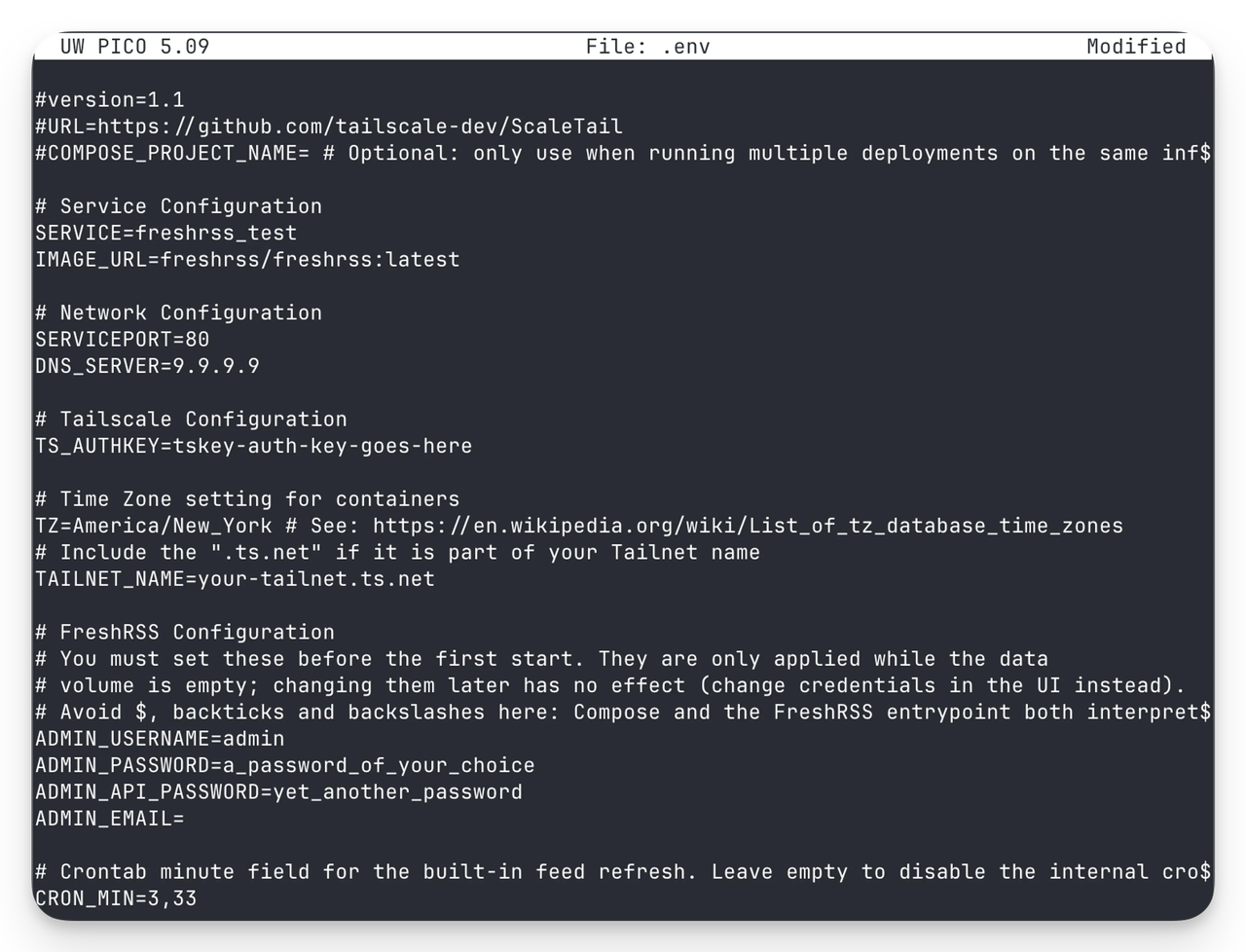 Environment configuration file (.env) for UW PICO 5.09 displaying FreshRSS service setup with network, Tailscale, timezone, and admin credential settings in dark terminal interface.